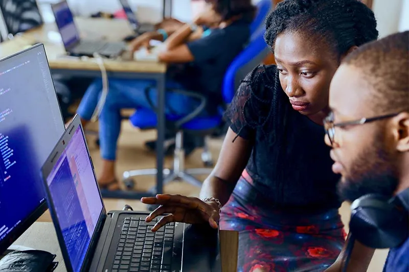 two young professionals working together on a laptop