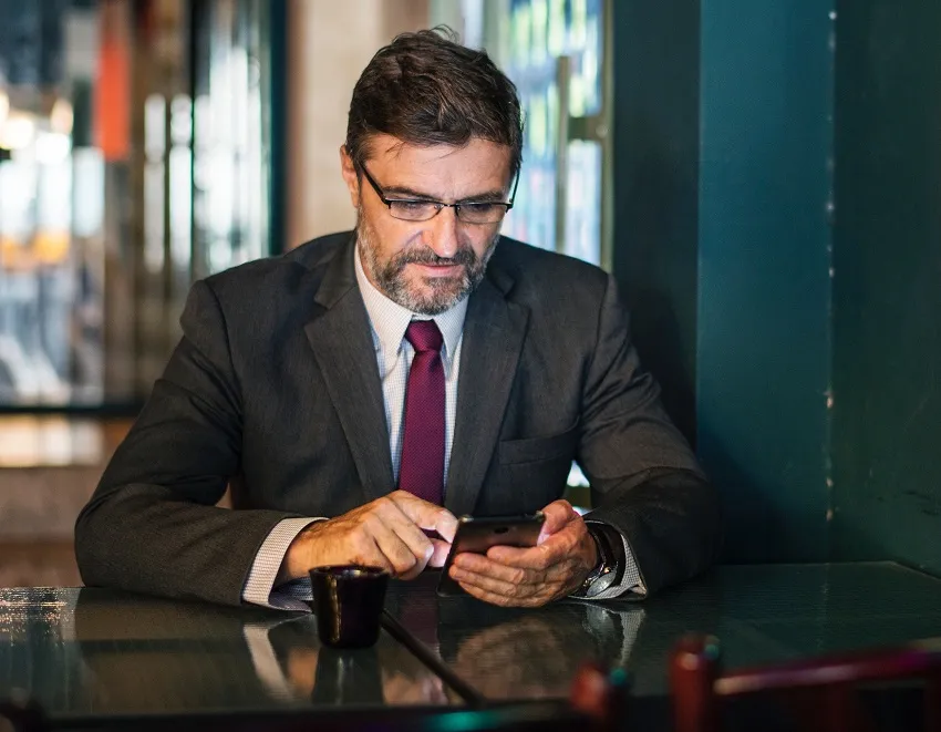 A man in an office with a cell phone